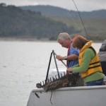 REx and Rae taking scallops from a dredge