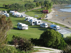 Campervans in a paddock where it's legal to park because they've kindly asked.